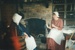 Tracy Mulgrew and another woman, both in costume, sitting by the fireplace in Briody-McDaniel's cottage.; La Roche, Alan; c2000; P2020.104.15