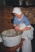 Jane Martinson bathing a baby, in costume inside Briody-McDaniels Cottage, formerly McDermott's Cottage at Howick Historical Village.

; La Roche, Alan; 1997; P2020.101.10
