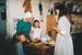 Lois Abram with Verity and Rowan Southern and another girl, in costume in Briody's Cottage, in Howick Historical Village.; P2021.105.20