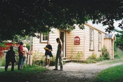 Visitors outside the Ararimu Valley School in the Howick Historical Village. ; 1989; P2020.21.10