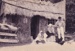 A lady, man and 2 girls in costume outside the Sod Cottage, Howick Historical Village on a Live Day.; La Roche, Alan; P2020.45.02