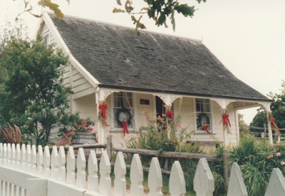 Christmas, past and present at Howick Historical Village, 12 December 1987. Sergeant Barry's cottage with Christmas decorations.; La Roche, Alan; 12 December 1987; P2021.194.08