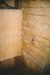 An interior room of Puhinui before restoration, showing a corner with bare boards.; Alan La Roche; May 2002; P202014.04