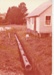 Blair Broughton beside the main drain, dug by John Litten, at Howick Historical Village.; December 1979; P2022.22.02
