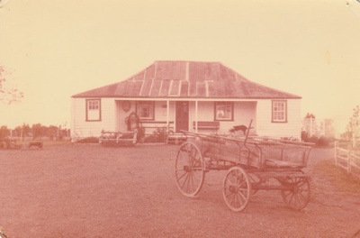 A wagon in front of Eckford's homestead in the Howick Historical Village.; La Roche, Alan; 29 March 1981; P2021.08.11
