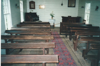 The interior of Howick Methodist Church at the Howick Historical Village, showing the pews, organ and pulpit.; La Roche, Alan; P2020.40.10