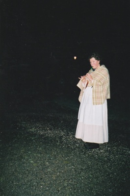 A guide in costume, playing a recorder during a Candle lit tour at Howick Historical Village, 27 May 2003. ; 27 May 2003; P2022.08.07