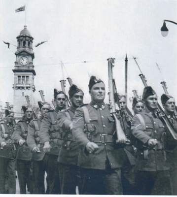 Howick Home Guard parading down Queen Street in 1945 at the end of the war.  Led by Lt. L B White and Lt L.Cr. Young.; White, Bruce; 22 August 1943; P2022.65.02