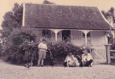 Children playing with chickens and ducks outside Sergeant Barry's cottage  in the Howick Historical Village.; La Roche, Alan; P2020.131.08