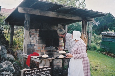 Brenda Scott and and Richard Lees, volunteers at Howick Historical Village, making bread at the bread oven behind the Kings Arms.; La Roche, Alan; P2020.89.08