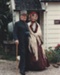 Gentleman and lady in costume outside Briody-McDaniels Cottage, formerly McDermott's Cottage at Howick Historical Village.

; P2020.101.03