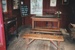 The interior of the Dame School at Howick Historical Village showing the teacher's desk, benches, a blackboard and other furniture.; La Roche, Alan; P2021.60.01
