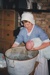 Jane Martinson bathing a baby, in costume inside Briody-McDaniels Cottage, formerly McDermott's Cottage at Howick Historical Village.

; La Roche, Alan; 1997; P2020.101.11