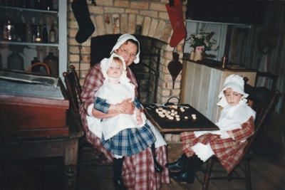 Brenda Scott (nee White) with two little girls on a Live Day in White's Store. All are in costume.; P2020.76.01