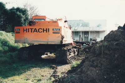 A digger preparing a road and carpark beside White's Homestead at Howick Historical Village.; La Roche, Alan; 6 November 1995; P2021.66.03