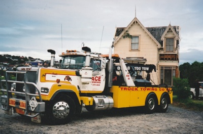 Ace Towing truck leaving Puhinui on its new site in the Howick Historical Village. ; Alan La Roche; May 2002; P2020.11.26