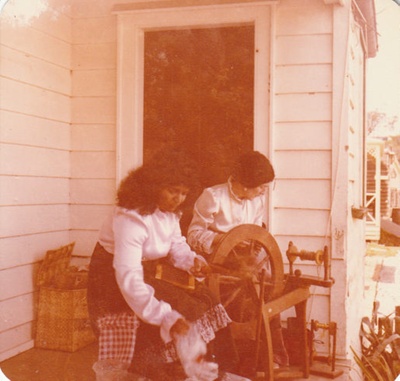 Two women spinning on Eckford's veranda; P2021.13.02