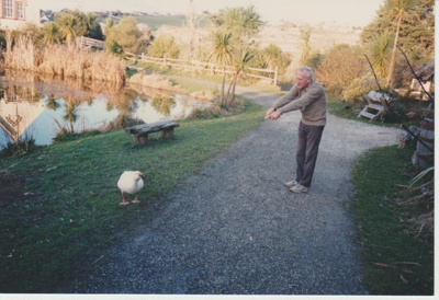 Kip Todd with a gander in front of the pond.; 2019.122.10
