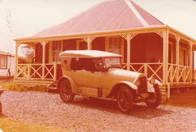 A vintage car in front of De Quincey's Cottage in Howick Historical Village.; La Roche, Alan; 16 November 1980; P2021.108.14