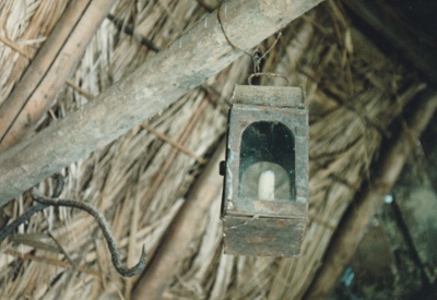 A lantern hanging from the rafter in the Sod Cottage, Howick Historical Village.; November 1989; P2020.49.01