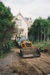 A bulldozer preparing the way for a Johnson's Heavy truck and trailer to move Puhinui to its new site in the Howick Historical Village.; Alan La Roche; May 2002; P2020.11.05