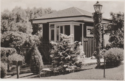 Miss Nixon sitting in front of her home.; Breckon, A.N.; 1947; 2019.091.04