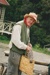 Alan la Roche (in costume) holding a kete (basket) in Howick Historical Village. ; P2021.118.17