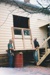Alan la Roche and David Wardlaw (builder) refitting a window in Puhinui after the move.; Alan La Roche; Sept 2003; P2020.11.18