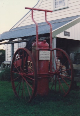 Vintage large wheeled fire extinguisher at Howick Historical Village. ; La Roche, Alan; 1990; P2020.18.21