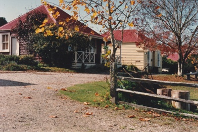 Colonel de Quincey's Cottage on Grey Street at Howick Historical Village, with Johnson"s on the right.; P2020.108.04