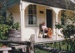 Wynn Pavitt spinning on the verandah at Sergeant Barry's cottage in Howick Historical Village. ; 1990; P2020.132.05