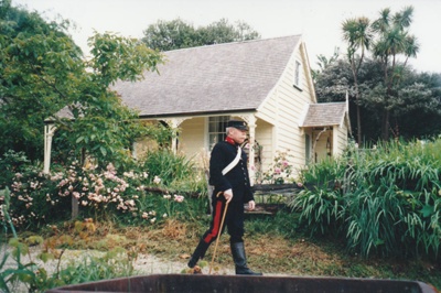 A soldier on the path outside Sergeant Barry's cottage in Howick Historical Village.; La Roche, Alan; P2020.131.05
