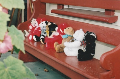 A display of teddy bears on a bench outside Brindle Cottage in the Howick Historical Village. ; La Roche, Alan; P2021.44.04