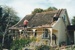 Two men reparing the roof of Sergeant Barry's cottage in Howick Historical Village. ; La Roche, Alan; August 1995; P2020.143.01
