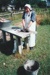 Debbie Benson in costume making bricks at an outside table on a Live Day at  HHV. ; December 2002; 2019.199.06