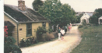 Looking along Grey Street towards the Methodist Church showing people at a Gala Day at Howick Historical Village.; 1984; P2021.176.03