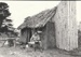 Arthur White in front of the Sod Cottage, Howick Historical Village 
; 6 November 1980; P2020.43.15
