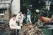 Prue and Richard Lees (left), Fred Chipperfield (right) and two other men working on the trench around the Sod Cottage, Howick Historical Village.; March 1977; P2020.48.05