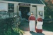 Adrienne Zupperich and a volunteer guide outside Wagstaff's Forge in Howick Historical Village. Two others are standing either side of the entrance.; 8 May 1994; P2020.157.06