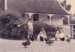 Children playing with chickens and ducks outside Sergeant Barry's cottage  in the Howick Historical Village.; La Roche, Alan; P2020.131.07