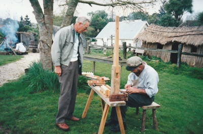 A visitor watching Richard Lees making clay pipes in Howick Historical Village.; P2021.128.07