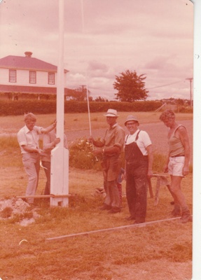 Alan la Roche, David Edwards (obscured), Arthur White. Jack Davis and Glen Taylor erecting the flagpole in Howick Historical Village.; 1980; P2021.114.03