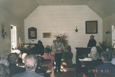 Rev. Frank Ashby dressed as Rev. Vicesimus Lush, in the pulpit of the Howick Methodist Church ih the Howick Historical Village. Harvest Festival April1999. Richard Lees is reading the Lesson.; La Roche, Alan; July 2002; P2020.37.02