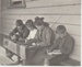 Howick School children sitting at and beside a school desk; Judkins, A J T; 1911-1912; 2019.075.03