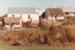 Looking across the pond to the sod cottage, Howick Methodist Church, Sergeant Barry's and the Parsonage at the Howick Historical Village. ; La Roche, Alan; 1983; P2020.50.17