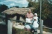 Tracy Mulgrew (left with broom) and Brenda Scott and her granddaughters (right) outside the mail runner's cottage in Howick Historical Village.; La Roche, Alan; P2021.83.07