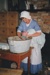 Jane Martinson bathing a baby, in costume inside Briody-McDaniels Cottage, formerly McDermott's Cottage at Howick Historical Village.

; La Roche, Alan; 1997; P2020.101.12