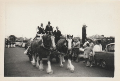 People in a horse-drawn wagon in the 1947 Centennial Parade.; 8 November 1947; P2022.38.21