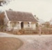 A man taking a photograph on the path outside Sergeant Barry's cottage in Howick Historical Village. ; P2020.140.01