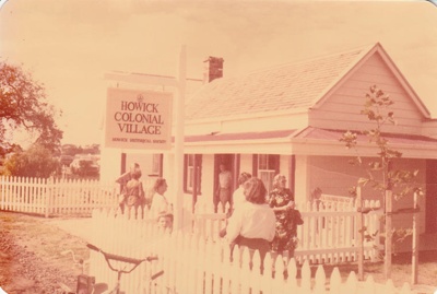 Visitors outside Brindle Cottage in the Howick Historical Village. It was then the entrance to the museum.; 8 March 1980; P2021.45.01